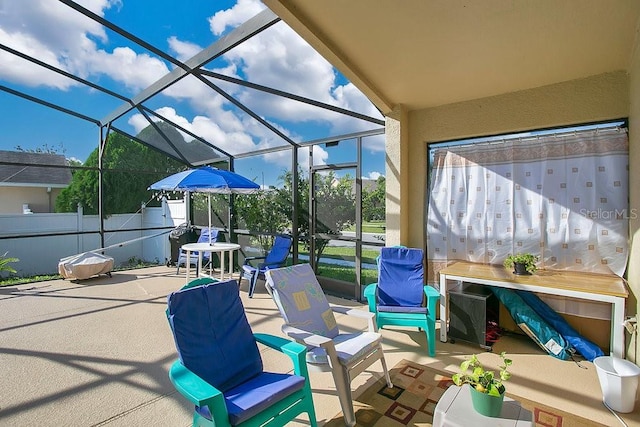 view of patio with glass enclosure