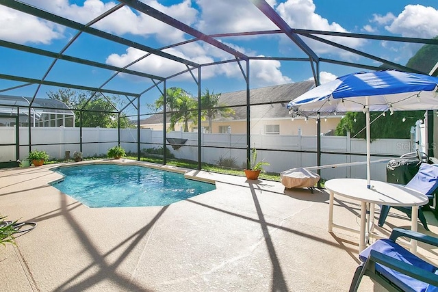 view of swimming pool with a patio area and a lanai