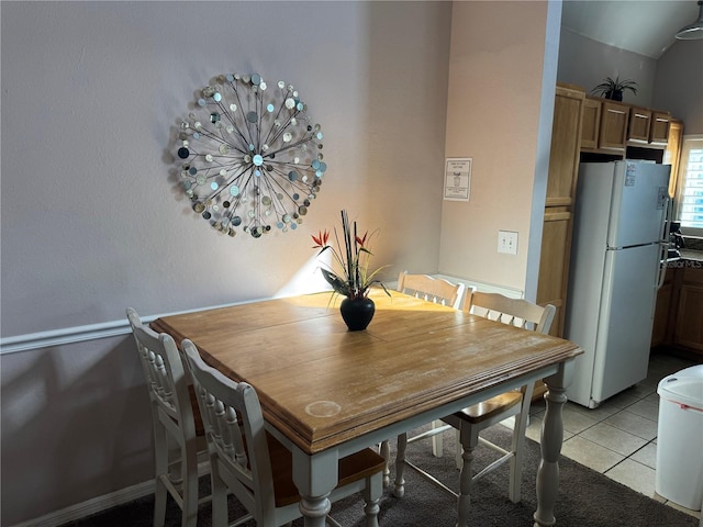 dining area with light tile patterned floors