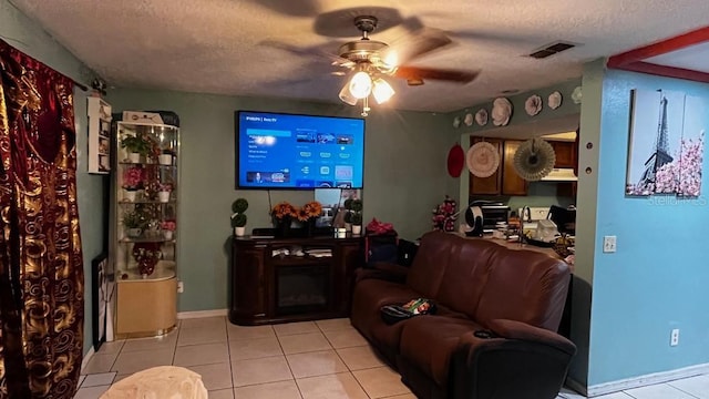 2440 Summerfield Way, Kissimmee, FL 34741 - living area with a textured ceiling, light tile patterned flooring, visible vents, a ceiling fan, and baseboards
