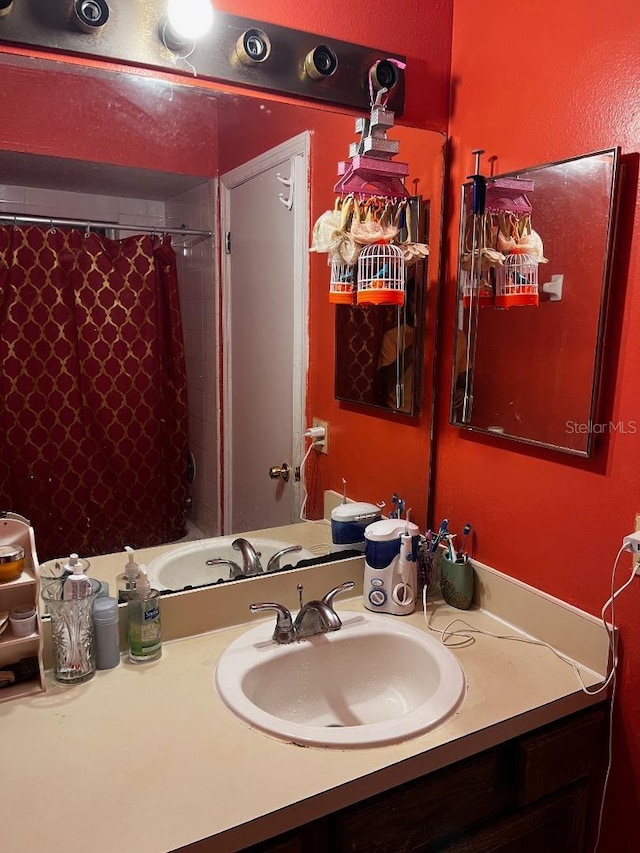 2440 Summerfield Way, Kissimmee, FL 34741 - bathroom featuring curtained shower, vanity, and a textured wall