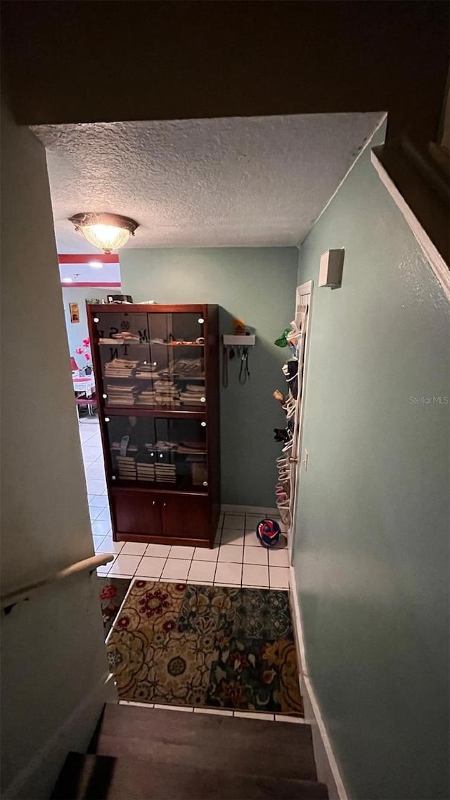2440 Summerfield Way, Kissimmee, FL 34741 - hall with tile patterned floors and a textured ceiling