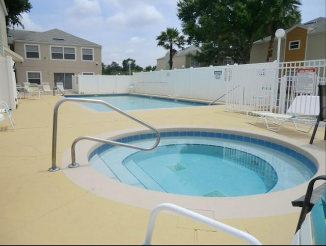 2440 Summerfield Way, Kissimmee, FL 34741 - community pool with a patio area, fence, and a community hot tub