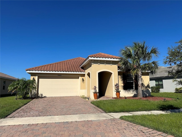 mediterranean / spanish home with a front yard and a garage