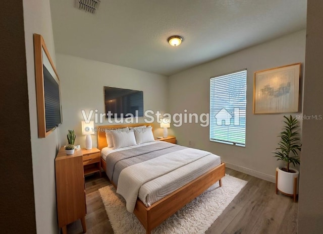 bedroom featuring dark hardwood / wood-style flooring