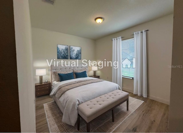 bedroom with hardwood / wood-style flooring