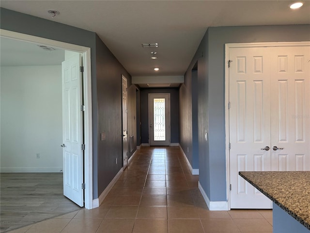 doorway to outside featuring light tile patterned floors