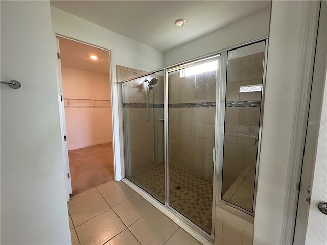 bathroom featuring walk in shower and tile patterned flooring