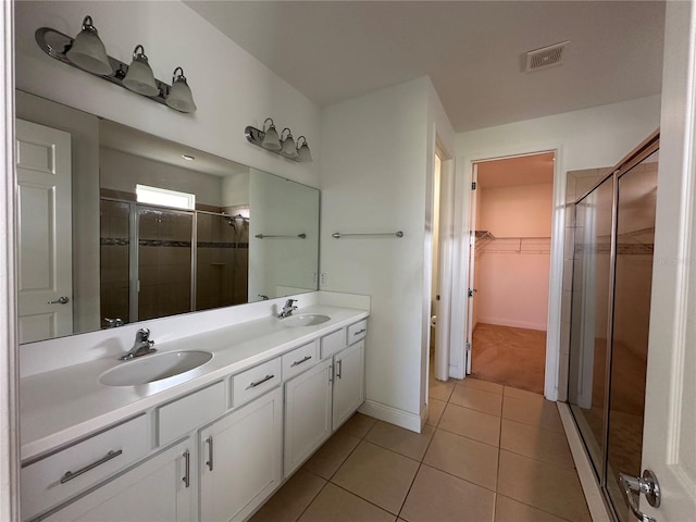 bathroom featuring vanity, tile patterned floors, and walk in shower