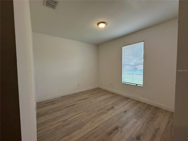 empty room with light hardwood / wood-style floors