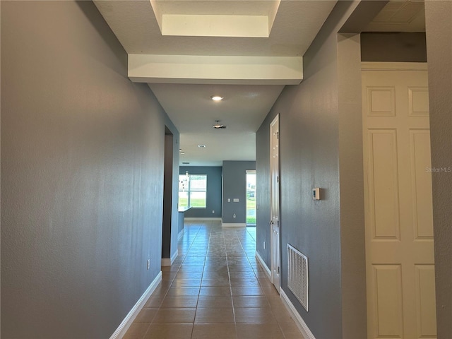 hallway with tile patterned flooring