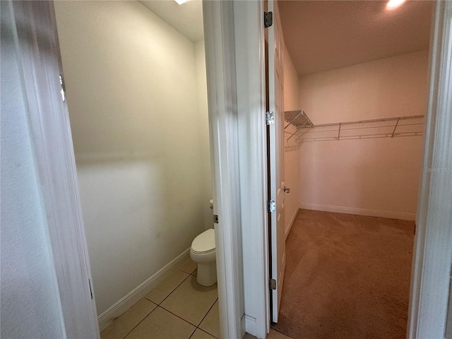 bathroom with toilet and tile patterned flooring