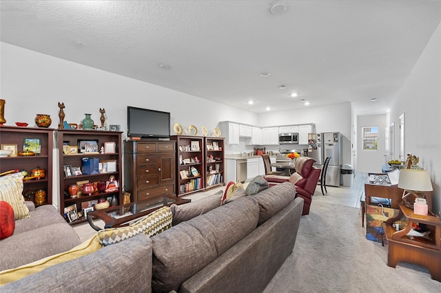 carpeted living room with a textured ceiling