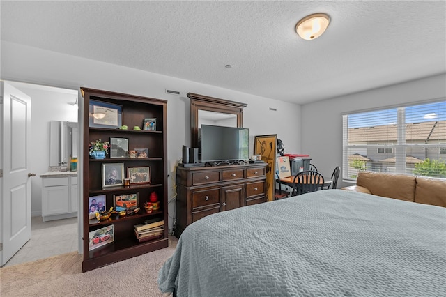 carpeted bedroom with a textured ceiling