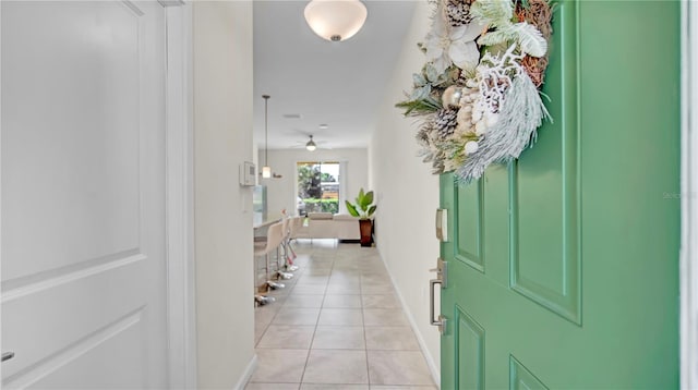 foyer entrance with light tile patterned flooring and ceiling fan