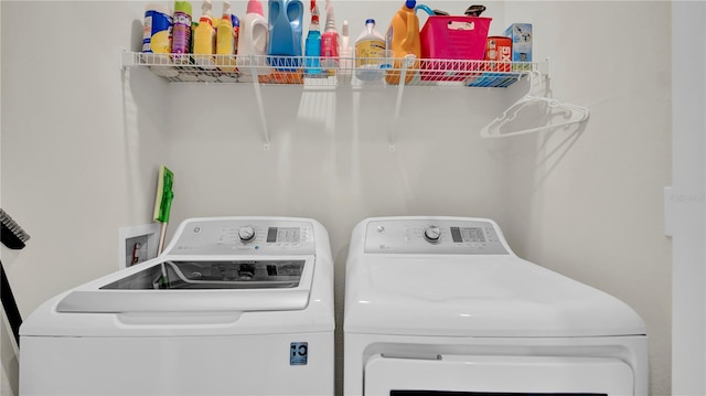 clothes washing area with independent washer and dryer