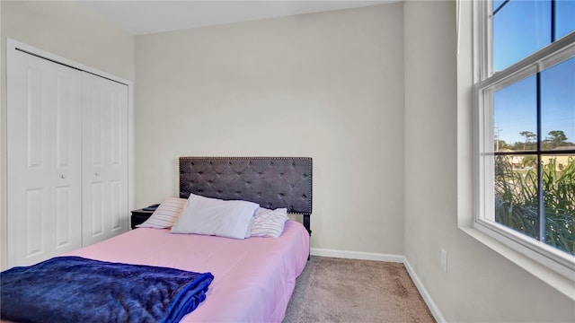 carpeted bedroom with a closet