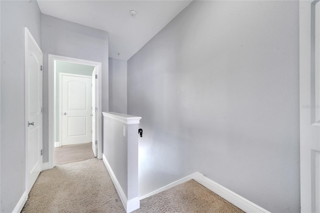 corridor featuring light colored carpet