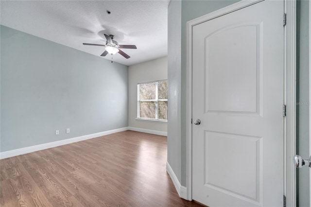 spare room with a textured ceiling, light hardwood / wood-style floors, and ceiling fan