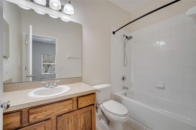 full bathroom featuring vanity, tiled shower / bath combo, toilet, and tile patterned flooring