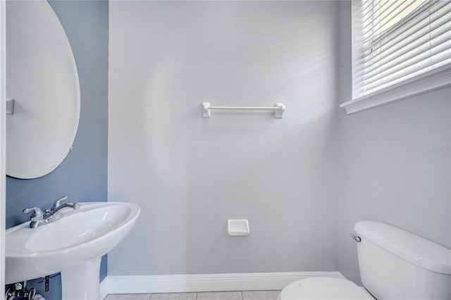 bathroom featuring toilet, sink, and tile patterned floors