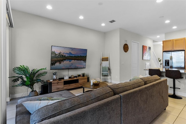 living area with recessed lighting, visible vents, baseboards, and light tile patterned floors