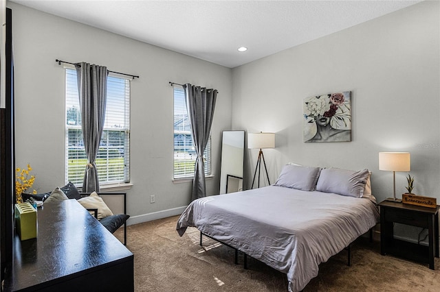 carpeted bedroom featuring recessed lighting and baseboards