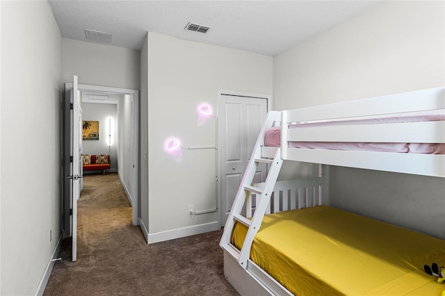 bedroom featuring carpet, visible vents, a closet, and baseboards