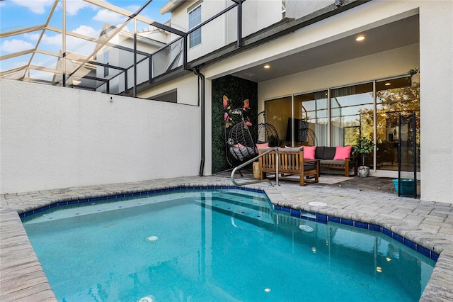 outdoor pool featuring a patio, a lanai, and an outdoor hangout area