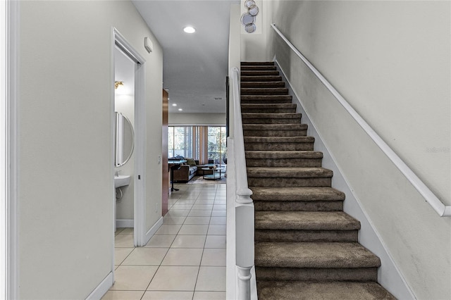 staircase with tile patterned floors, recessed lighting, and baseboards