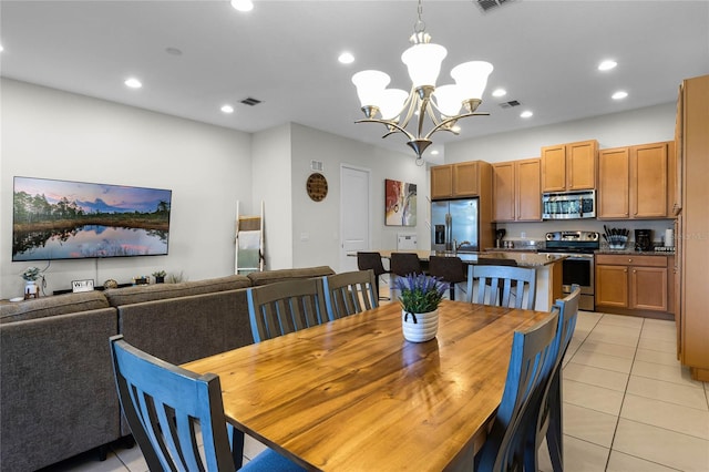 dining space with light tile patterned floors, visible vents, recessed lighting, and a chandelier