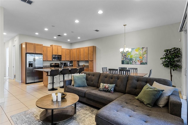 living room featuring an inviting chandelier, light tile patterned flooring, recessed lighting, and visible vents