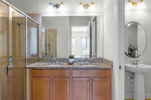 bathroom featuring double sink and a stall shower