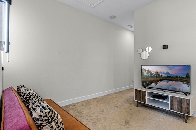 carpeted living area with baseboards