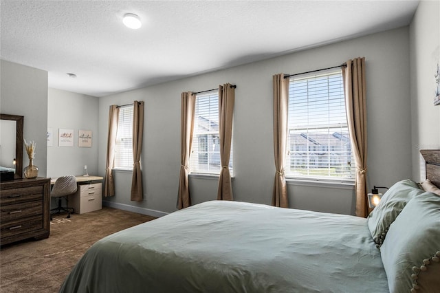 bedroom featuring carpet flooring, a textured ceiling, and baseboards