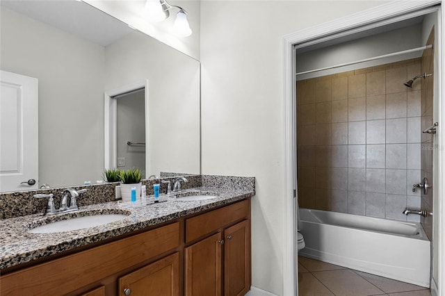 bathroom with tile patterned flooring, double vanity, toilet, and a sink