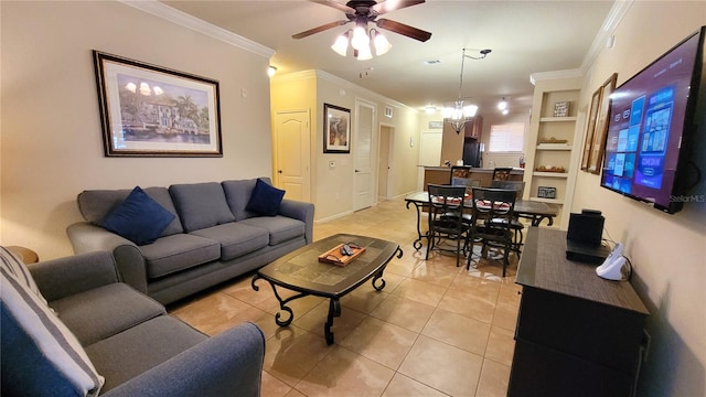 living room with crown molding, ceiling fan with notable chandelier, built in features, and light tile patterned floors