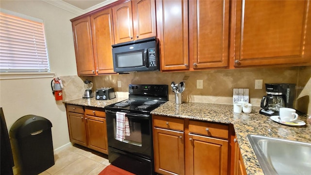 kitchen with decorative backsplash, black appliances, light tile patterned flooring, crown molding, and light stone counters