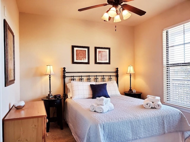 bedroom with ceiling fan and carpet flooring