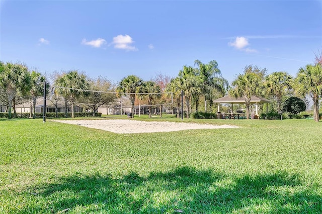 view of property's community featuring a gazebo, a lawn, and volleyball court