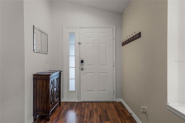 entryway with dark hardwood / wood-style flooring and vaulted ceiling