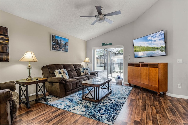 living room featuring ceiling fan, a textured ceiling, vaulted ceiling, and dark hardwood / wood-style floors