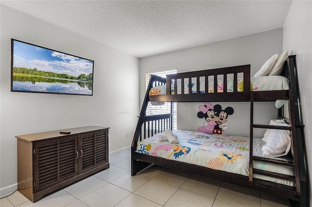 bedroom with a textured ceiling and light tile patterned flooring