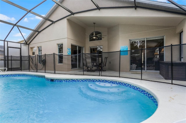 view of pool featuring a patio, ceiling fan, and glass enclosure