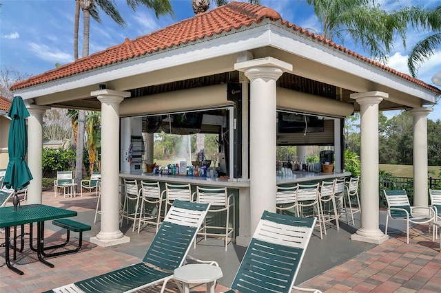 view of patio / terrace with a gazebo and exterior bar