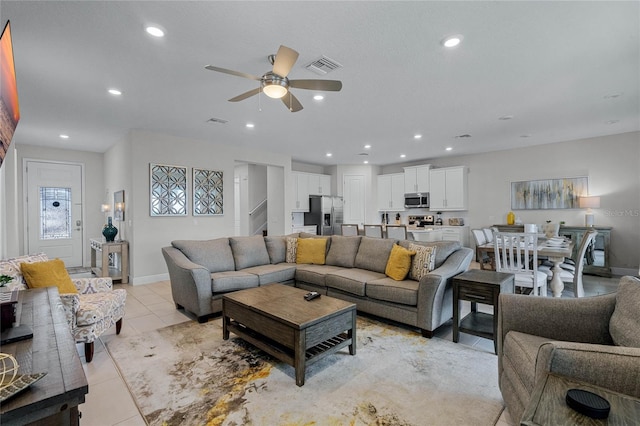 living room featuring light tile patterned flooring and ceiling fan