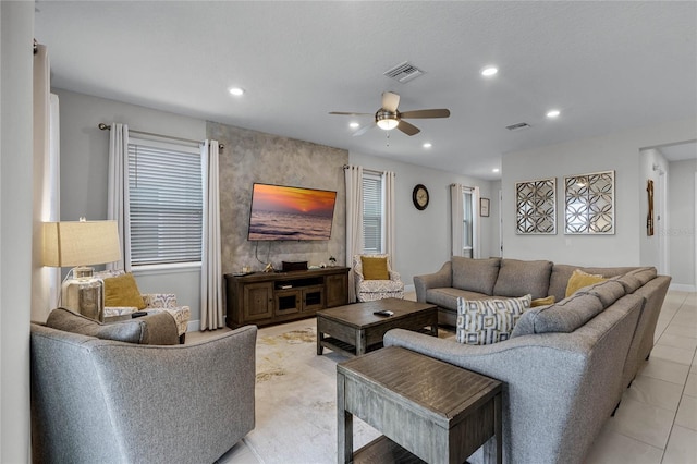 tiled living room featuring ceiling fan