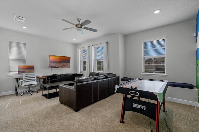 living room with light carpet and ceiling fan