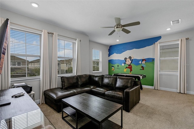 carpeted living room with ceiling fan