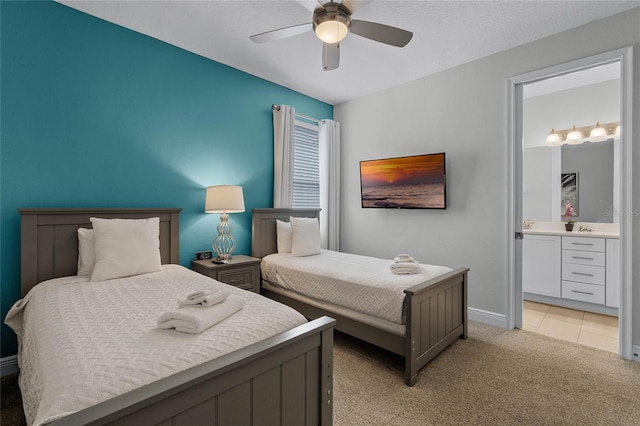 carpeted bedroom featuring ensuite bath and ceiling fan